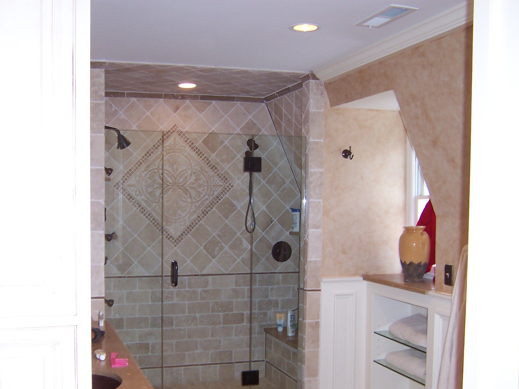 Tiled walk-in shower with glass door