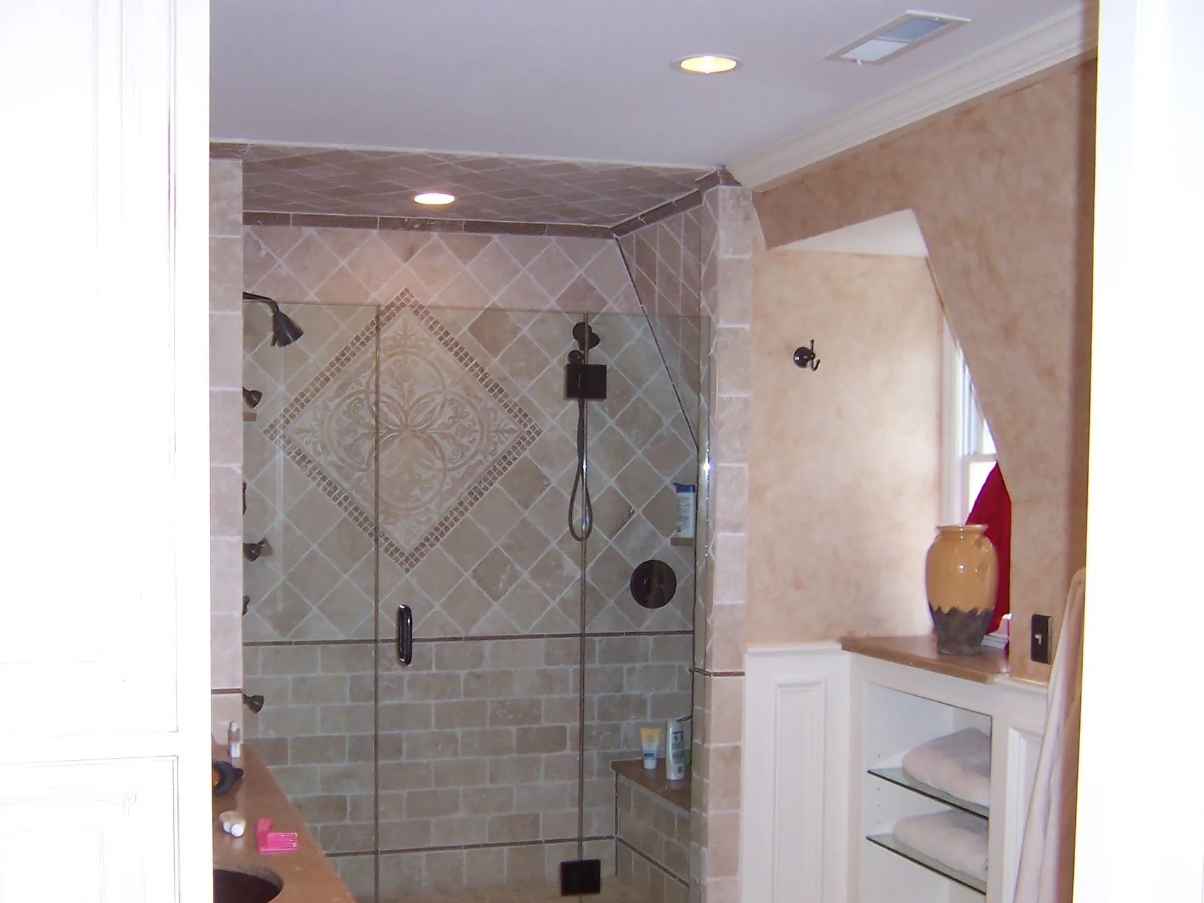 Tiled walk-in shower with glass door